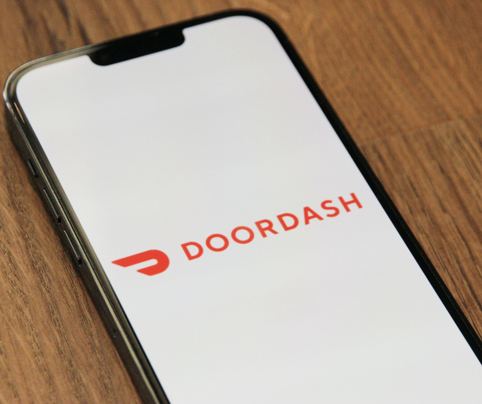 mobile phone with DoorDash logo displayed.